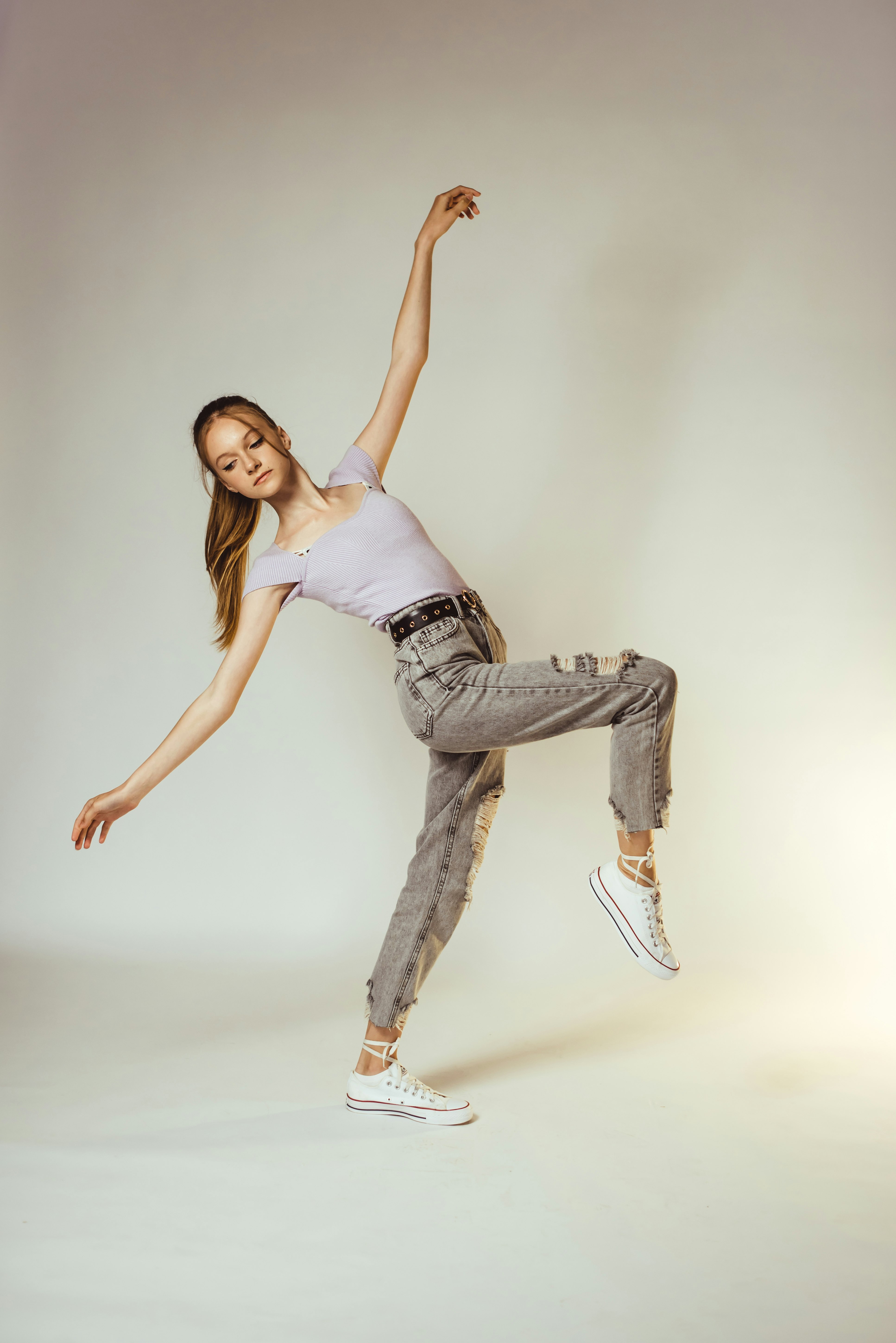 woman in white tank top and gray denim jeans